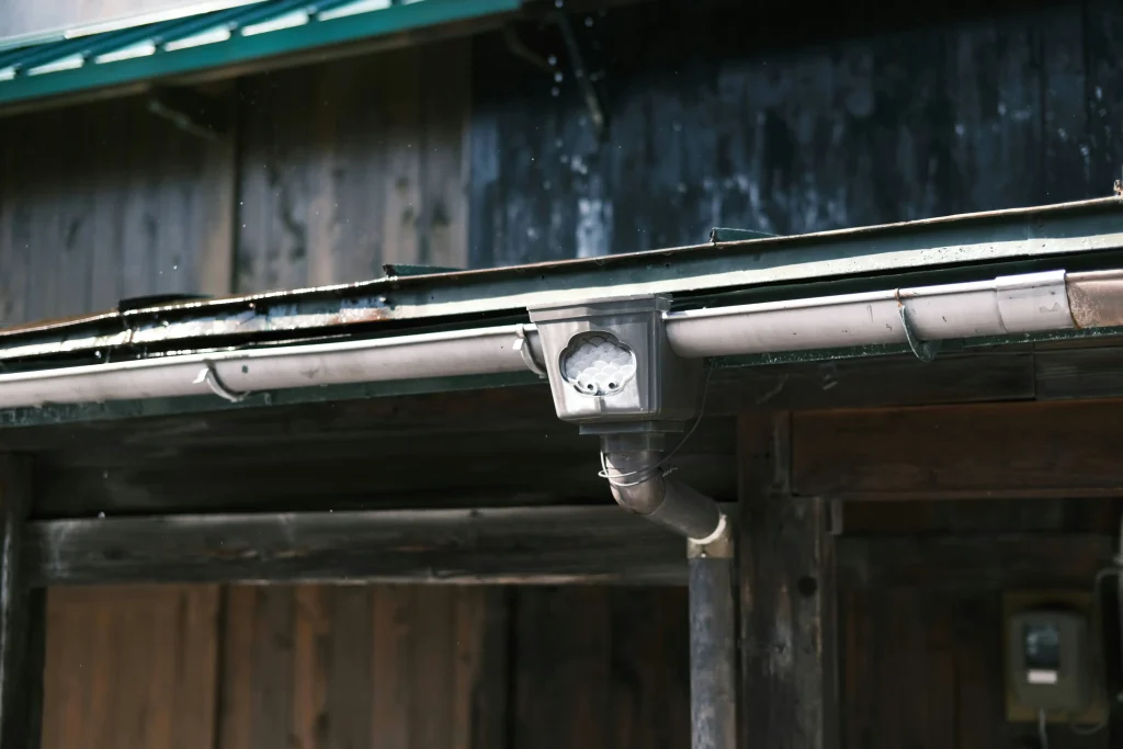 Aging gutter system showing worn joints and downspout connections
