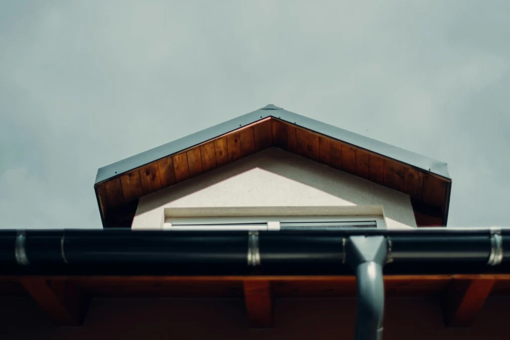 Clean gutter and downspout along a home roofline